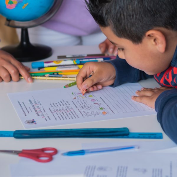Closeup of a Hispanic child studying at home with his teacher Closeup of a Hispanic child studying at home with his teacher